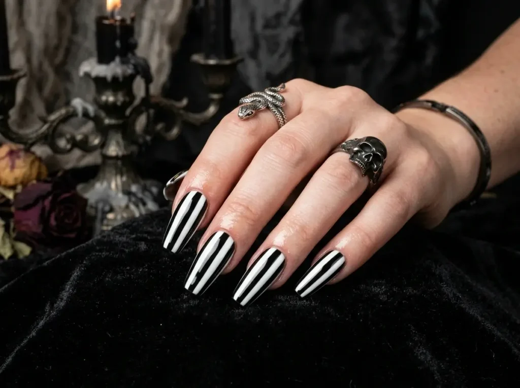 20 Spooky Nail Designs for Halloween 2026: Creepy, Dark & Haunting Ideas 18 black and white striped spooky Halloween nail design with a gothic aesthetic