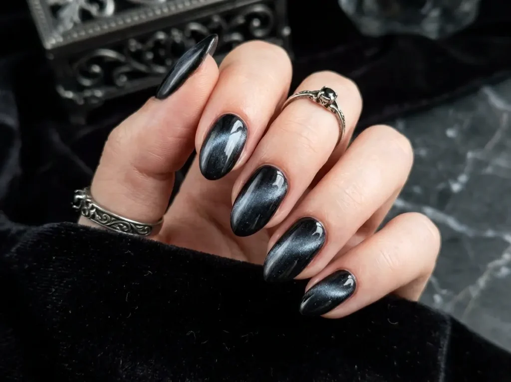 15 Classy Halloween Nails That Look Expensive (Short, Black & Almond) 4 Obsidian black velvet cat-eye Halloween nails with a dimensional magnetic finish