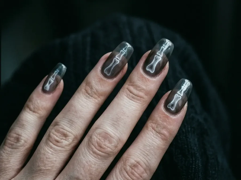 20 Spooky Nail Designs for Halloween 2026: Creepy, Dark & Haunting Ideas 7 eerie Halloween nails with glowing white X-ray finger bone designs