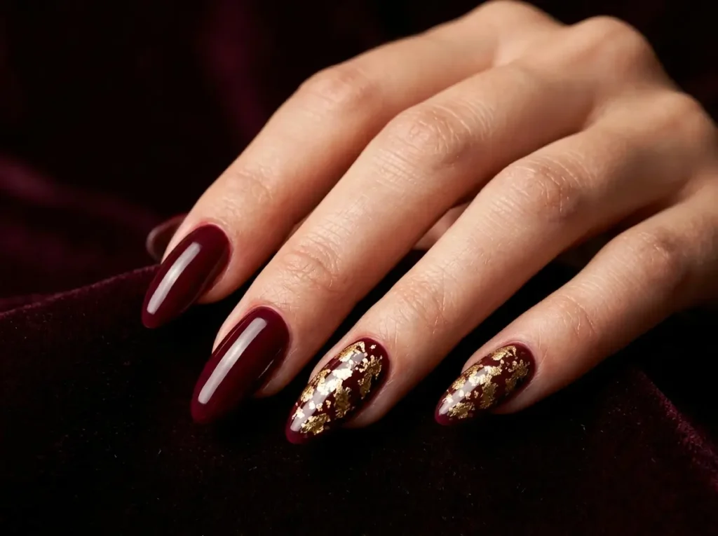 Burgundy Nail Designs: 18 Classy Ideas for Every Nail Shape (2026) 7 burgundy nails decorated with delicate gold foil accents