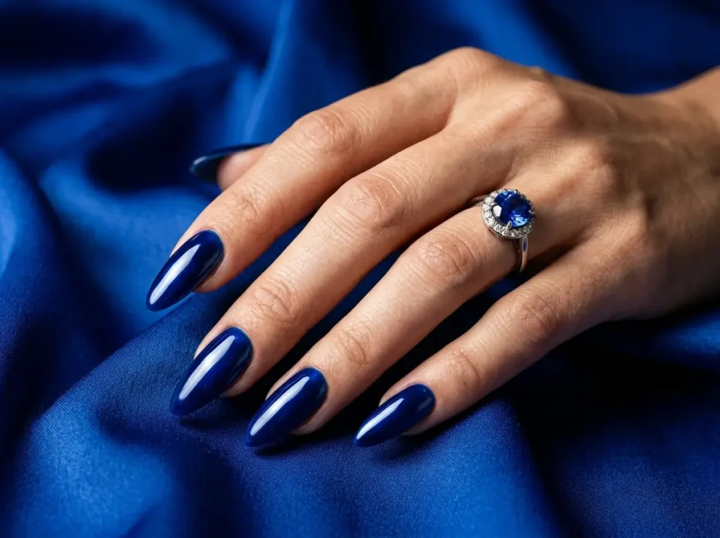 September Nail Ideas 2026: 15 Pretty Designs for the Summer-to-Fall Transition 5 deep sapphire blue September nail color on almond nails
